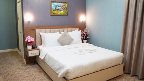 Ένα ή περισσότερα κρεβάτια σε δωμάτιο στο Royal Meridien Hotel
