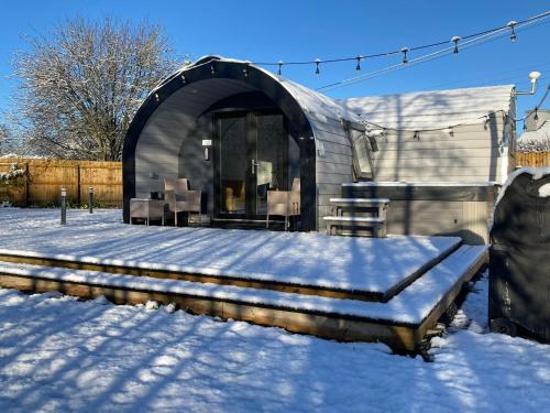 a dome shaped home in the snow with snow on the ground at The Pod at Gerycoed in Llangadog