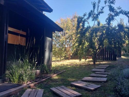 a row of wooden steps next to a building at Cabañas Bella vista Ruca hue in San Martín de los Andes