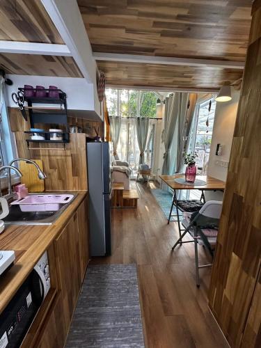 a kitchen with a refrigerator and a table at Oniro 2 Beachfront Tiny House at Koh Samui in Ban Na We