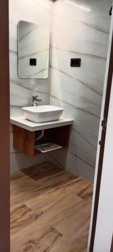 a bathroom with a sink and a mirror at Hotel Spring Vilas in Gorakhpur
