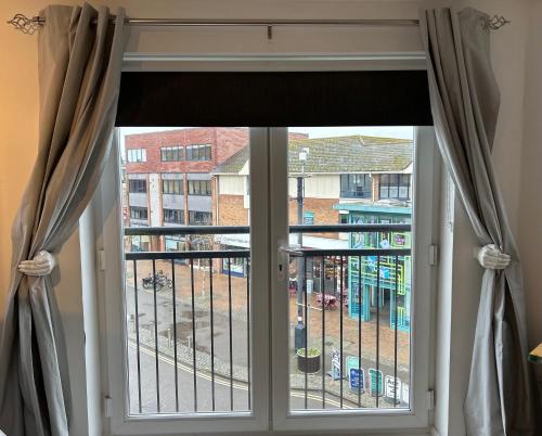 a window with a view of a building at 2 Bed Charming Corner Position Apartment in Kidlington
