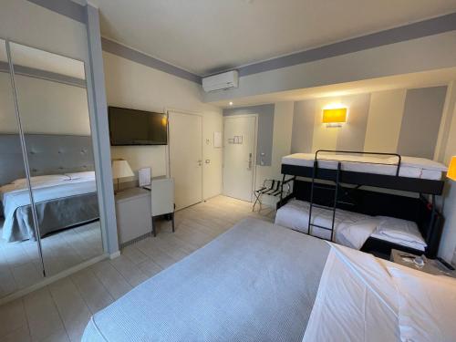 a hotel room with two beds and a mirror at Boutique Hotel Calzavecchio in Casalecchio di Reno