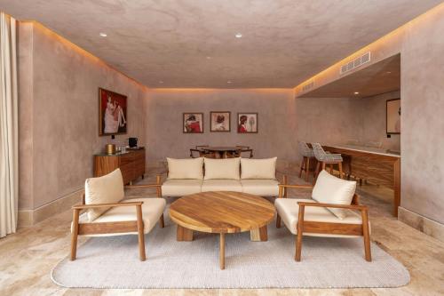 a living room with a couch and a table at Almare, a Luxury Collection Resort, Isla Mujeres, Adult All-Inclusive in Isla Mujeres