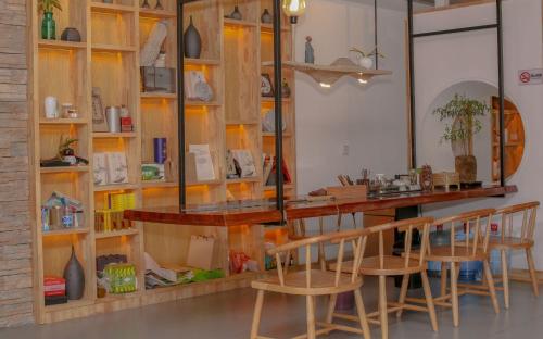 a bar in a room with wooden shelves and chairs at Cozy Boutique Hotel in Zhangjiajie