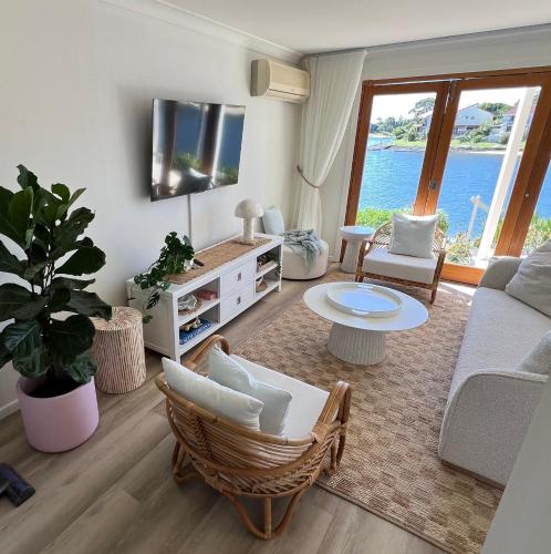 a living room with a couch and a table at VILLA AQUILA - Mermaid Waters in Gold Coast