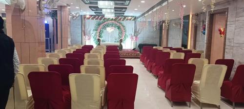 a row of chairs in a room with a altar at Hotel The Coal in Alīgarh