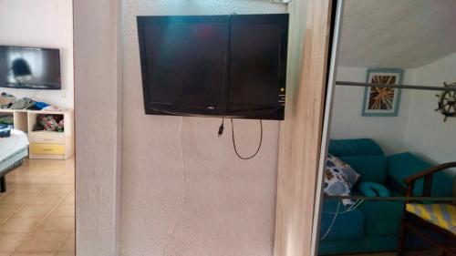 a flat screen tv on the wall of a living room at Villa di Esperanza in Comarruga