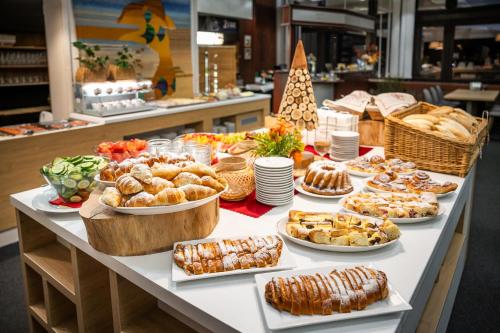 a table with many different types of food on it at Hotel Adamantino in Luhačovice