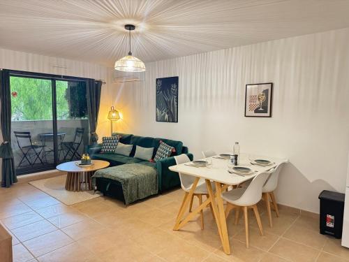 Spacieux 2 pieces au Port de Nice في نيس: غرفة معيشة مع أريكة وطاولة مع كراسي