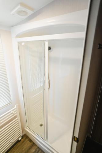 a glass door in a room with a window at Beautiful 3bed Caravan on Windermere - on White Cross Bay Holiday Park in Troutbeck Bridge