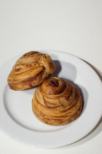 two croissants on a white plate on a table at Nano Oia Canaves in Oia