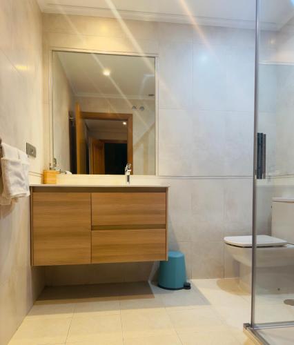 a bathroom with a sink and a toilet at APARTAMENTO EN PRIMERA LINEA DE PLAYA RiAZOR in A Coruña