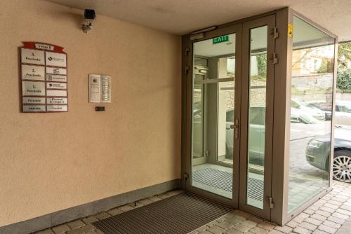 an entrance to a building with a revolving door at P23 Apartments in Bratislava