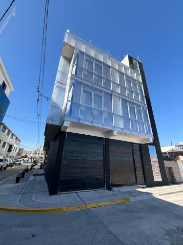 a building with glass windows on the side of a street at HOTEL PIEDRA SANTA - Moquegua in Moquegua