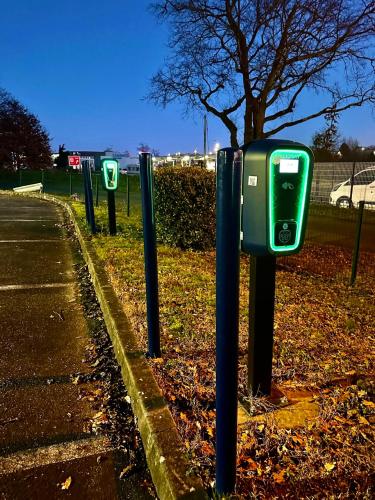 a row of parking meters on the side of a road at Sure Hotel by Best Western Mont-de-Marsan in Saint-Pierre-du-Mont