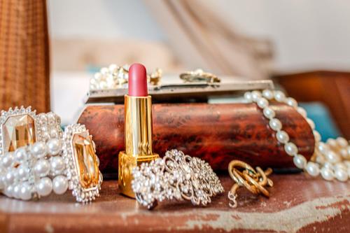 a pile of diamonds and a lipstick on a table at Altalena Luxury Rooms and Spa in Siena