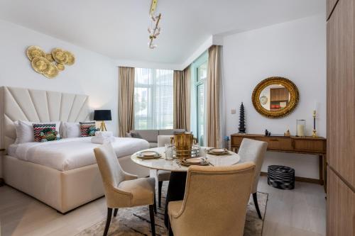 a living room with a bed and a table and chairs at Missoni Luxury Life Suite DPA Direct Pool Access in Dubai