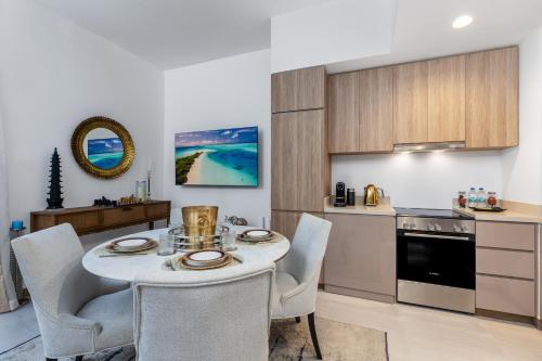 a kitchen and dining room with a table and chairs at Missoni Luxury Life Suite DPA Direct Pool Access in Dubai