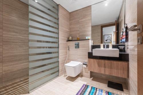 a bathroom with a white toilet and a sink at Missoni Luxury Life Suite DPA Direct Pool Access in Dubai