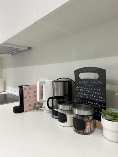 a kitchen counter with a coffee maker and appliances at Im home in Perea