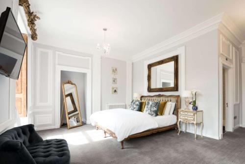 a white bedroom with a bed and a mirror at Beamish Hall Hotel, BW Premier Collection in Stanley