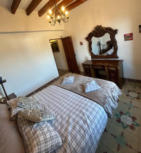 a bedroom with a bed and a mirror at La guarida rústica del zorro in Jijona