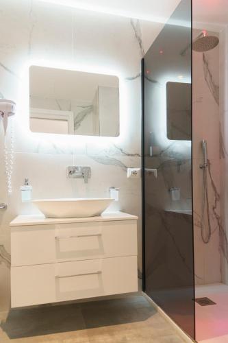 a bathroom with a sink and a shower at Piazza Venezia Grand Suite in Rome