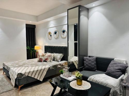 a bedroom with a bed and a couch at luxury private studio In Zirakpur in Ghaggar