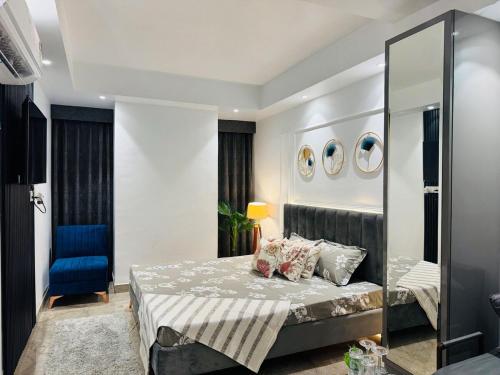 a bedroom with a bed and a mirror at luxury private studio In Zirakpur in Ghaggar
