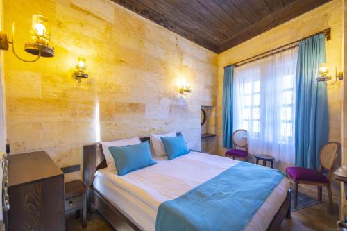 Postel nebo postele na pokoji v ubytování ARIEN CAVE Hotel