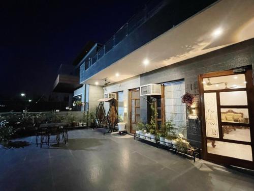 a building with a patio at night at Black pearl Villa panchkula sector 28 in Panchkula