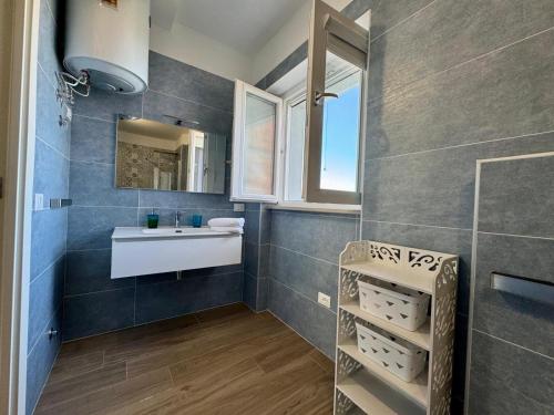 a bathroom with a sink and a mirror at Borgo Ninni - CASA CARLY in San Vito Chietino