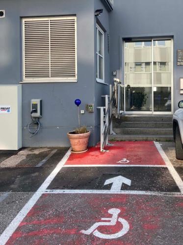 a building with a handicapped sign on a red floor at Apartment Winterhafen in Linz