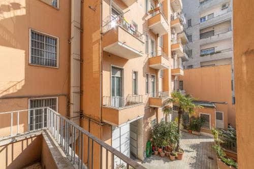 an apartment building with balconies and potted plants at Leia Hospitality in Milan