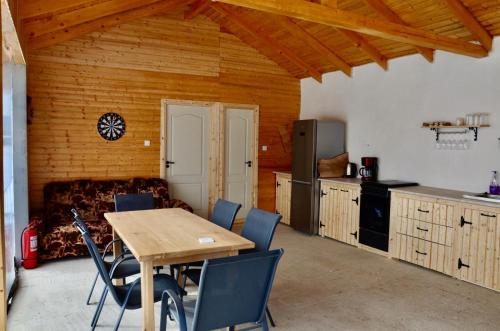 a kitchen with a table and chairs and a couch at Cabana Teo&Matei in Mihăeşti
