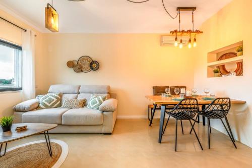 a living room with a couch and a table at Serenity Costa da Caparica in Almada