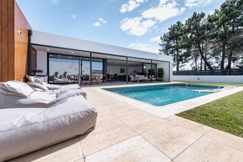 a swimming pool in the backyard of a house at Casa da Oliveira ~ Azeitão in Azeitao
