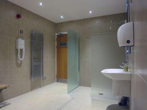 a bathroom with a shower and a sink at 6 Burgh Island in Kingsbridge