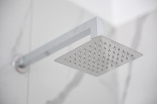 a ceiling light hanging from a white wall at Leia Hospitality in Milan