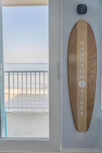 a door with a surfboard sticking out of it at Hampton Tides-Ocean View-Top Floor With Balcony in Hampton