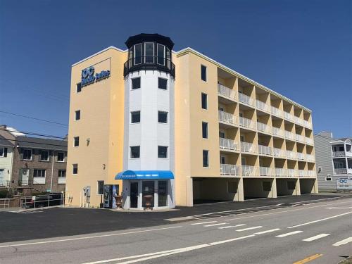 a building with a clock tower on the side of a street at Hampton Tides-Ocean View-Top Floor With Balcony in Hampton