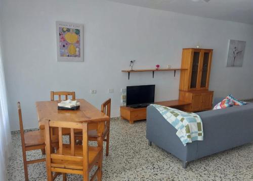 a living room with a table and a couch at Casa Ermita El Medano in El Médano
