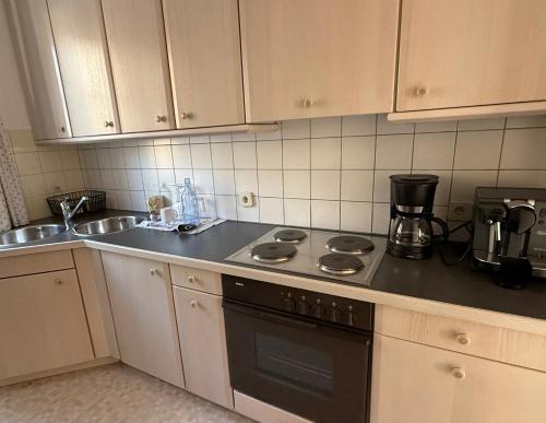 a kitchen with a stove and a sink at Ville Bianche in Drobollach am Faakersee