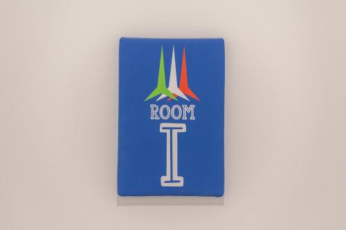 a sign for a room with the logo on it at Leia Hospitality in Milan
