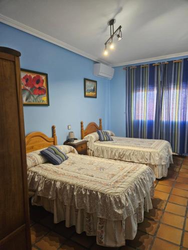 Postel nebo postele na pokoji v ubytování Casa Rural El Hollejo
