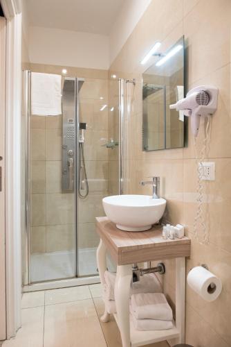 a bathroom with a sink and a shower at Certosa Suite in Naples