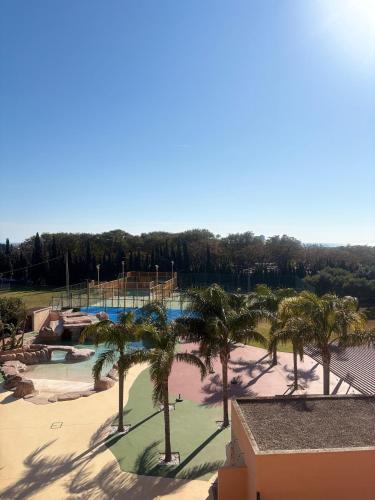a resort with palm trees and a water park at Cambrils Paradise in Cambrils
