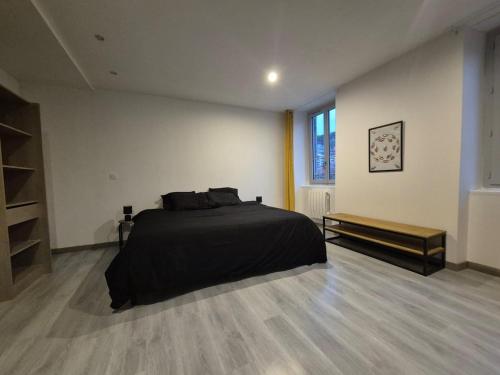 une chambre avec un lit noir et une fenêtre dans l'établissement #Le Coin Perché #Thiers #Auvergne, à Thiers