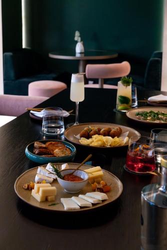 a table with several plates of food on it at Hotel Mundial in Lisbon